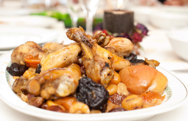 chicken thighs on a plate with dried peaches, apples and prunes