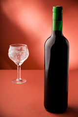 bottle with red wine and glass