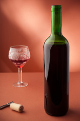 bottle with red wine and glass