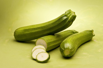 Zucchini on green background