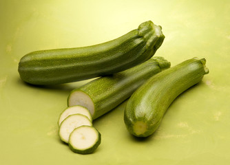 Zucchini on green background