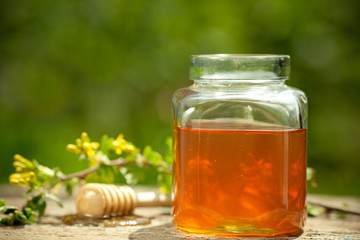 Flowery honey in glass jar