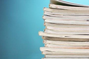 stack of magazines on blue background