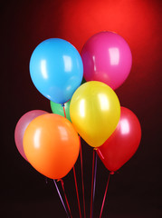 bright balloons on red background
