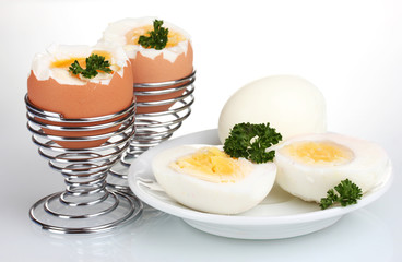 tasty boiled eggs and parsley isolated on white