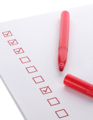 Checklist and red marker isolated on white