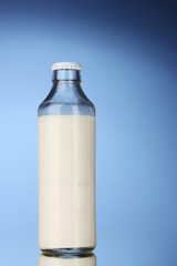 bottle of milk on blue background