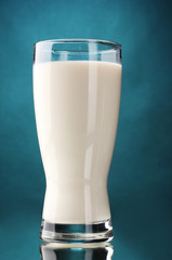 glass of milk on blue background