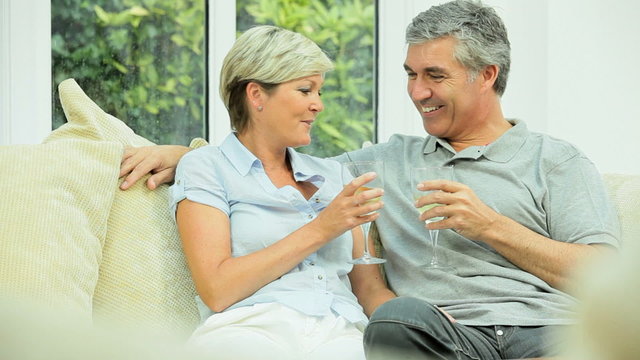 Middle Aged Couple Relaxing with Glass of Wine