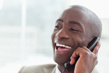 Close up of a laughing businessman on the phone