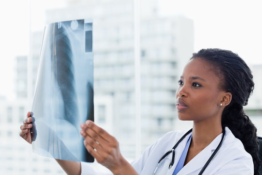 Female doctor looking at a set of X-rays