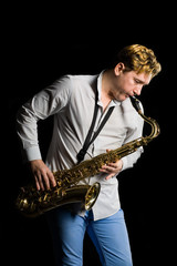 Fototapeta na wymiar Young musician with a saxophone