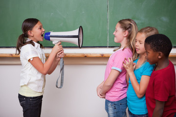 Schoolgirl yelling through a megaphone to her classmates