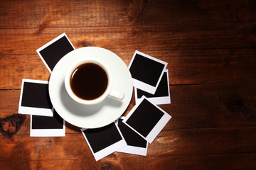 Fototapeta na wymiar Photo papers with coffee on wooden background