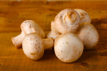 champignons mushrooms in basket on wooden table