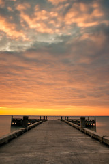 Fototapeta premium Dramatic golden cloud and pier
