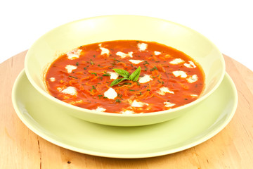 Tomato soop with chopped parsley and mozzarella cheese