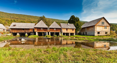 Fototapeta na wymiar Rural landscape - wooden mill houses in Sinac, Croatia