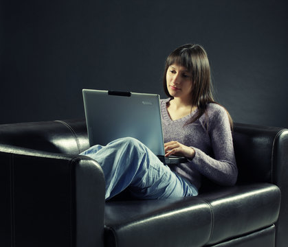 young woman using laptop computer, copy space