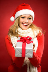 Young woman giving christmas gift