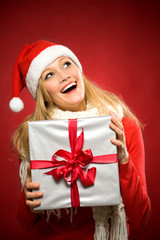 Woman in Santa hat holding gift