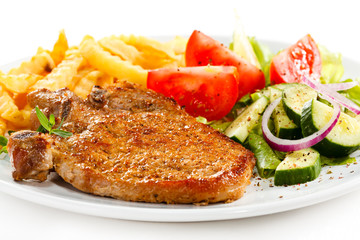 Fried pork chop with French fries and vegetable salad