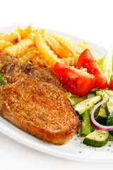 Fried pork chop with French fries and vegetable salad