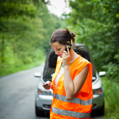 Young female driver calling the roadside service