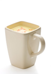 Vegetable soup in a cup on white background.