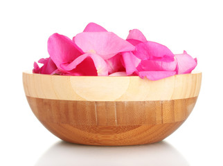 beautiful pink rose petals in wooden bowl isolated on white