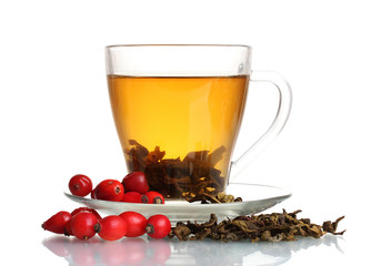 Green tea  with red viburnum and  hips in glass cup isolated