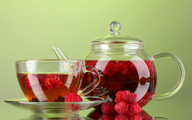 Black fruit raspberry tea in glass teapot and cup