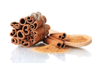 Cinnamon sticks and powder in wooden spoon isolated on white