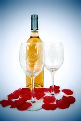 Glasses, bottle of wine and rose petals composition