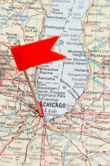 Pin pointing Chicago on map in atlas