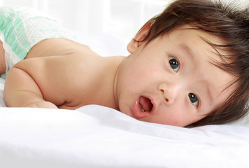 baby laying in the bed.