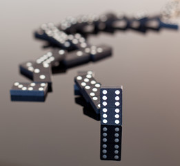 Dominoes collapsed on reflective surface