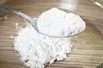 White wheat flour in a metal spoon