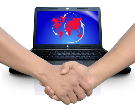 handshake in front of Computer notebook with global network