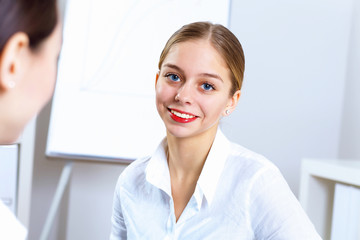 Young women in business wear working in office