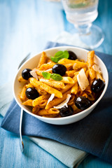 Penne pasta with pesto sauce and parmesan