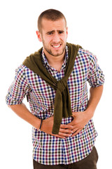 Young man with strong stomach pain isolated on white background