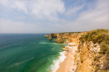 Fototapeta na wymiar Idyllic wild beach in summertime. Algarve, Portugal.