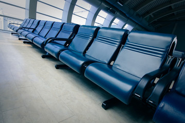 row of blue chair at airport