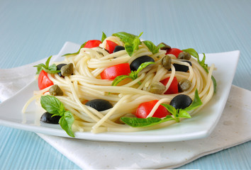 Spaghetti with tomato, capers and basil with olives