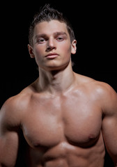 Chest-low portrait of the muscular young naked sexy boy