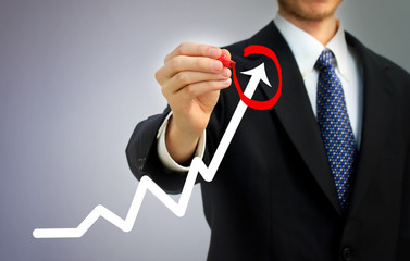 Businessman circling a rising arrow