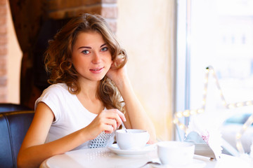 Young pretty woman sitting in restaurant