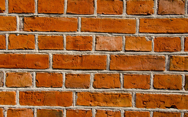 Wall built of red brick architectural details.
