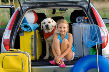 Girl with dog ready for travel for summer vacation